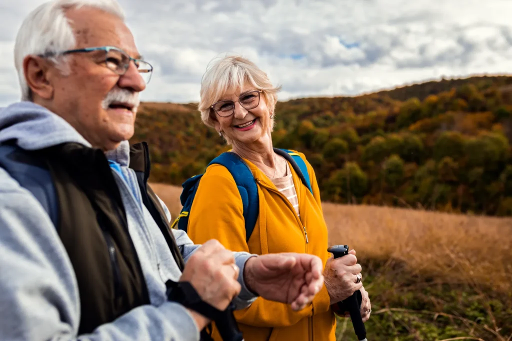 cataract-surgery-blog-senior-couple-hiking-2000 Senior couple hiking outdoors in nature, smiling and enjoying an active lifestyle